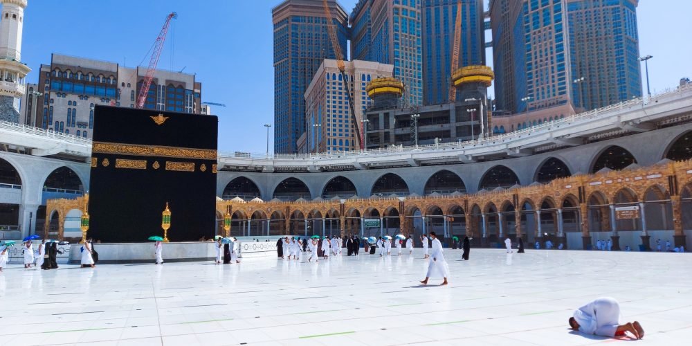 Pilgrims in Kaaba in Macca al Haram - umrah Covid 19 coronavirus restrictions face mask
